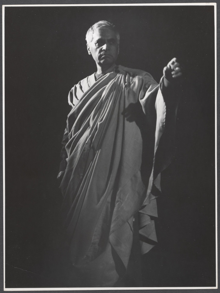 Na czarno-białym zdjęciu aktor na scenie w roli Ulpianusa podczas spektaklu Irydion.